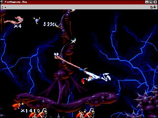Earthworm Jim: Special Edition Screenshot (Activision website, 1996): Buttville: Using his body as a whip to propel him to higher places, Earthworm Jim is on his way to Princess What's-Her-Name and the final battle with Queen Slug-For-a-Butt.