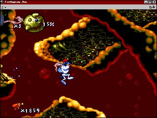 Earthworm Jim: Special Edition Screenshot (Activision website, 1996): Intestinal Distress: Attempting to eliminate "Doc Duodendum" with a massive burst from his Plasma Blaster, Earthworm Jim must master this level in order to advance to the next.