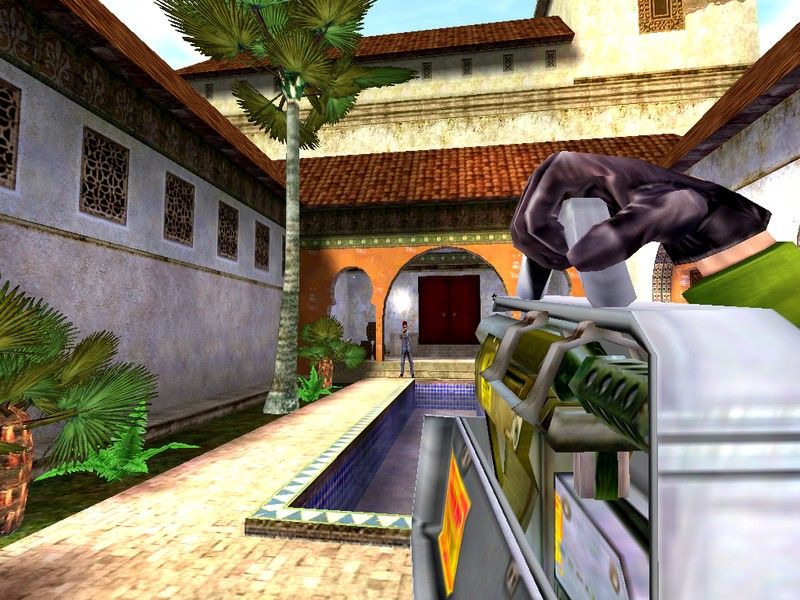 The Operative: No One Lives Forever Screenshot (Official website, 2003): Archer uses a briefcase rocket launcher to defend herself against a H.A.R.M. henchman beside the Grand Caravan Hotel. Surveillance Photos section (Morocco)