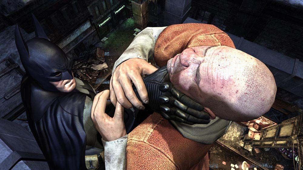 Batman: Arkham City Screenshot (Xbox.com product page): Batman interrogating an inmate