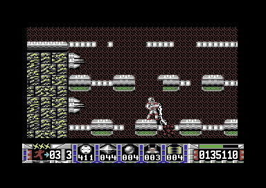 Turrican (Commodore 64) screenshot: Using the rotatable laser to clear the way