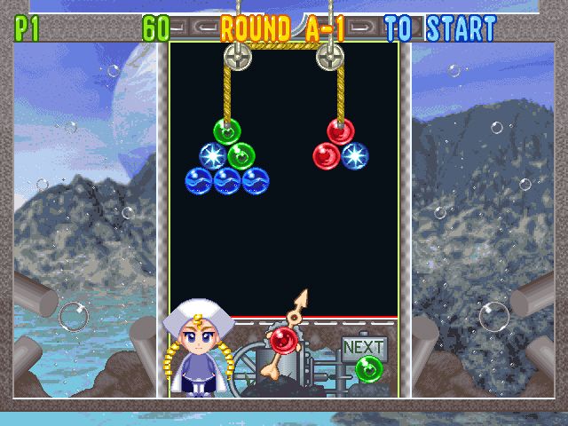 Bust-A-Move 4 (Windows) screenshot: When you hit one of those star bubbles with a bubble of a certain color, all bubbles with that color are removed
