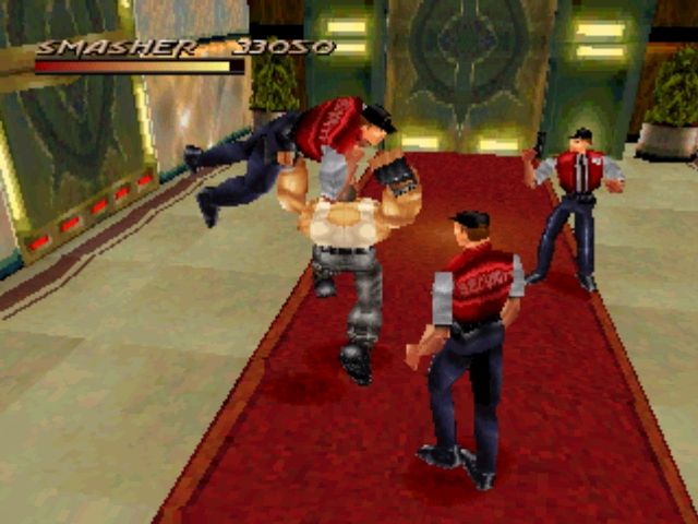 Fighting Force (PlayStation) screenshot: Smasher...er...SMASH! The brute force character about to demonstrate how he got his name.