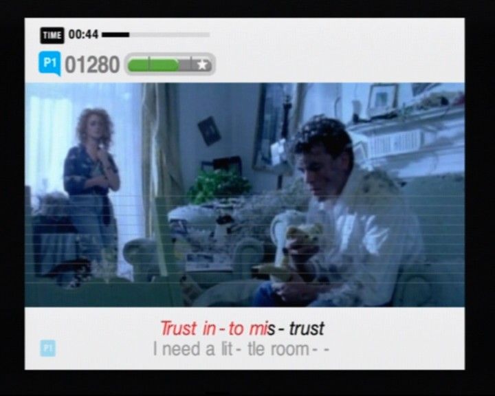 SingStar: Party (PlayStation 2) screenshot: When you sing a duet without another player, you will be able to figure what to sing by the player mark and the color on the lyrics