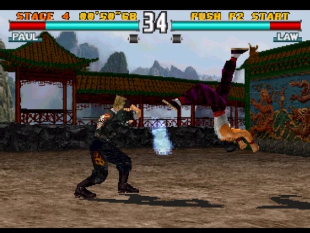 Tekken 3 (PlayStation) screenshot: Laying down the Law. Many characters have pretty maneuvers and the backgrounds, though non-functional, are also pleasing to look at.