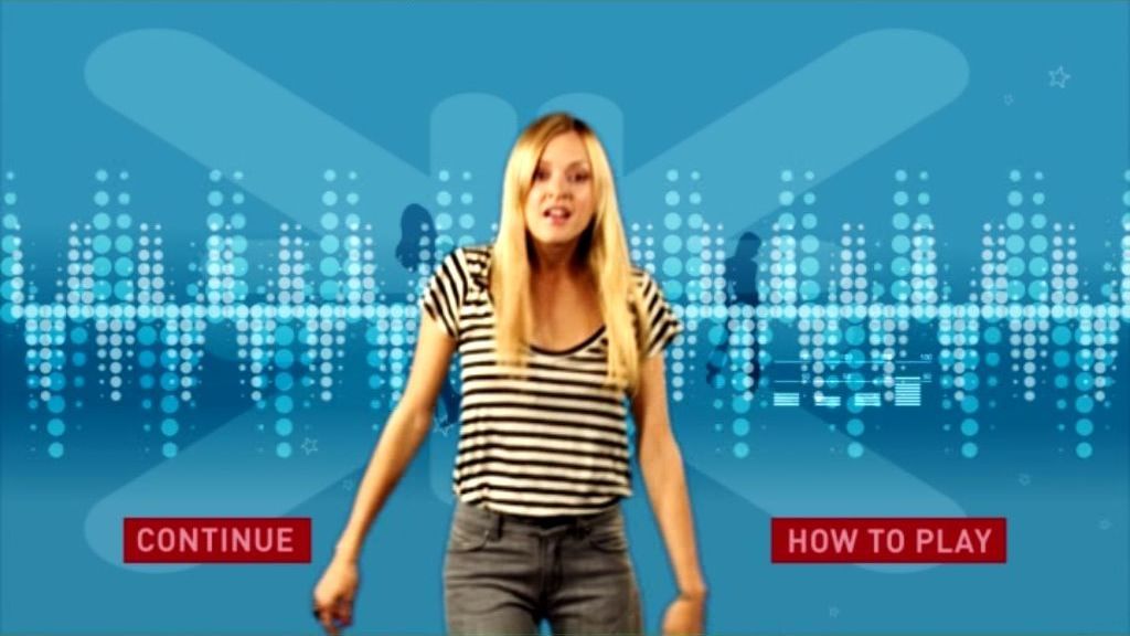 The X Factor: Interactive TV Game (DVD Player) screenshot: The start of Round One. All rounds start with a graphic which Fearne pushes/thumps out of the way, she then outlines how the round is played