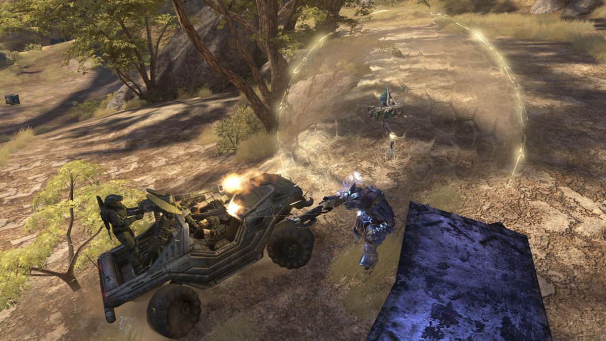 Halo 3 (Xbox 360) screenshot: Running over a brute in a warthog in co-op. He has deployed the new bubble shield, which won't protect the grunt inside from being run down as well.