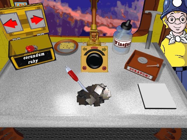 Scholastic's The Magic School Bus Explores Inside the Earth (Windows) screenshot: At the geo table, the player can perform scratch tests and experiments on items from the rock box
