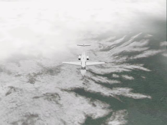 Pro Pilot '99 (Windows) screenshot: Above a mountain range in the Citation jet.