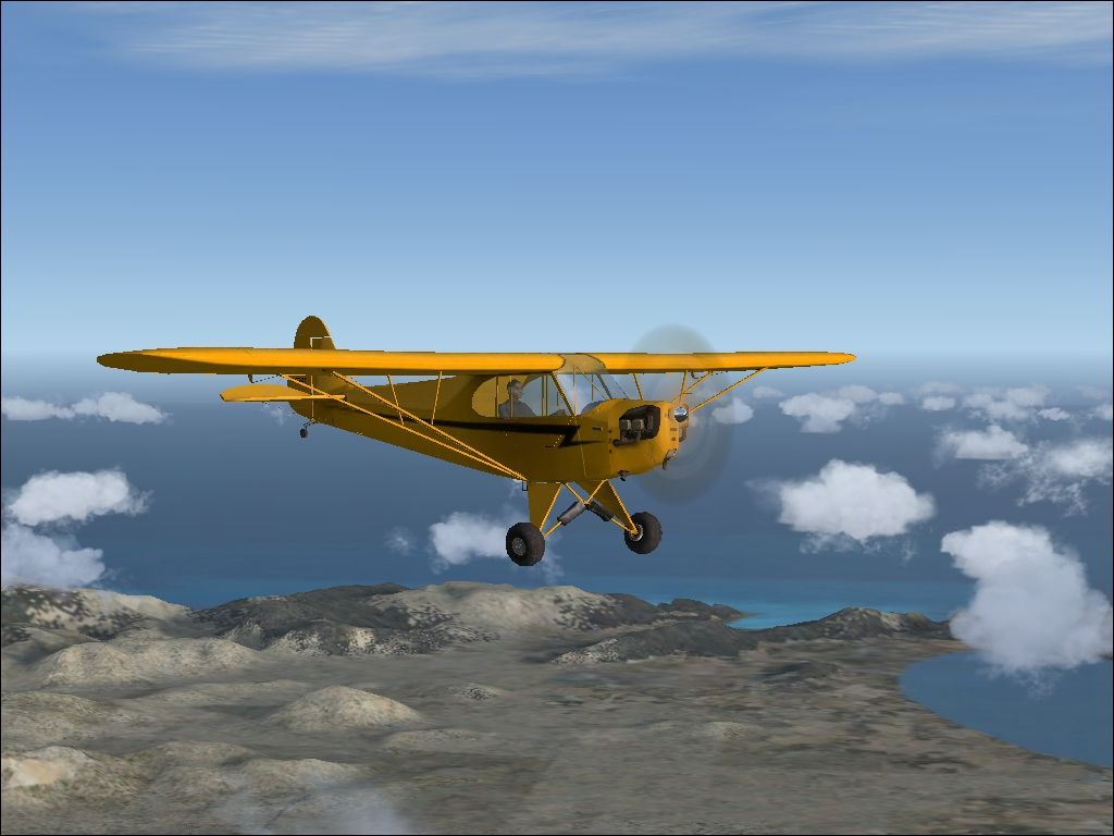 Microsoft Flight Simulator X (Windows) screenshot: Piper J-3 Cub flying over Mallorca
