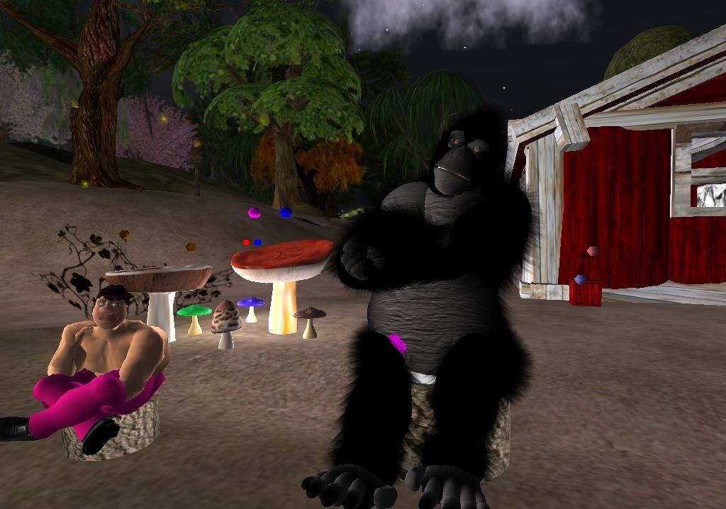 Second Life (Windows) screenshot: Sitting at a cozy fire next to a gorilla