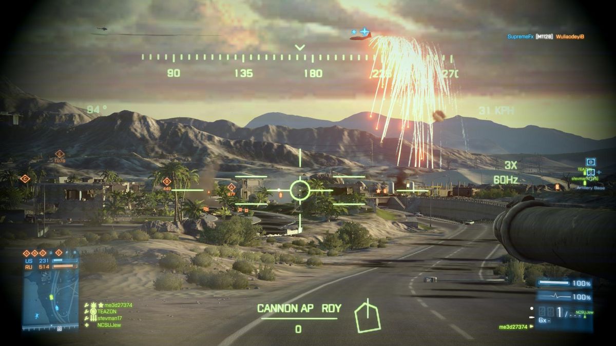 Battlefield 3: Armored Kill (Windows) screenshot: My M1 Tank firing at enemy armor in town but above our team Gunship pops IR Flares given the enemy attack chopper upper left fires a missile (smoke trail) headed for the Gunship