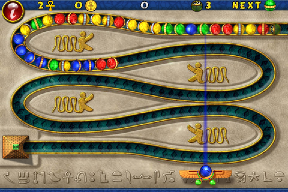 Luxor (iPhone) screenshot: Colored balls begin to snake towards the pyramid