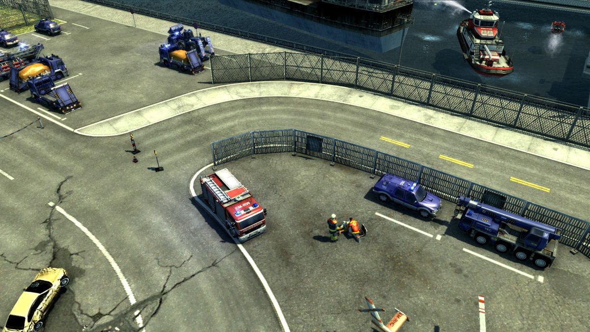 Emergency 2012 (Windows) screenshot: Flyover the training facilities showing some technical relief vehicles and a fire fighter and an emergency doctor at work.