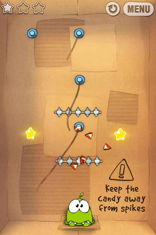 Cut the Rope (iPhone) screenshot: Level 1-16, when the candy touches the spikes it breaks and Omnom puts on his pouty face