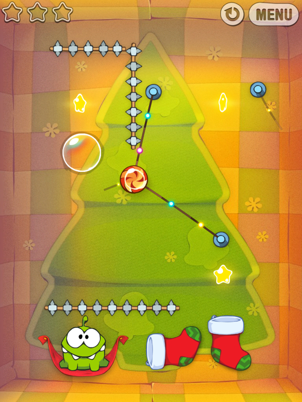Cut the Rope (iPad) screenshot: Don't let the candy touch these spiky things!