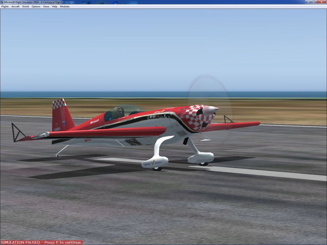 Microsoft Flight Simulator 2004: A Century of Flight (Windows) screenshot: This is the Extra 300S, an acrobatic plane that's flown by Patty Wagstaff on the tarmac at Crown Point airport, Trinidad and Tobago
