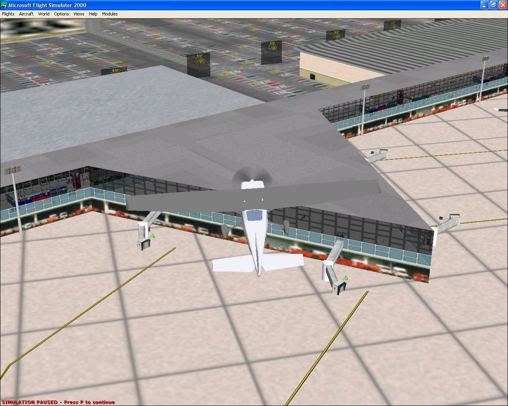 Airport 2000: Volume 2 (Windows) screenshot: Through the windows the detail inside the building looks impressive but other parts such as the car park and the airport vehicles parked below the departure lounge look less impressive