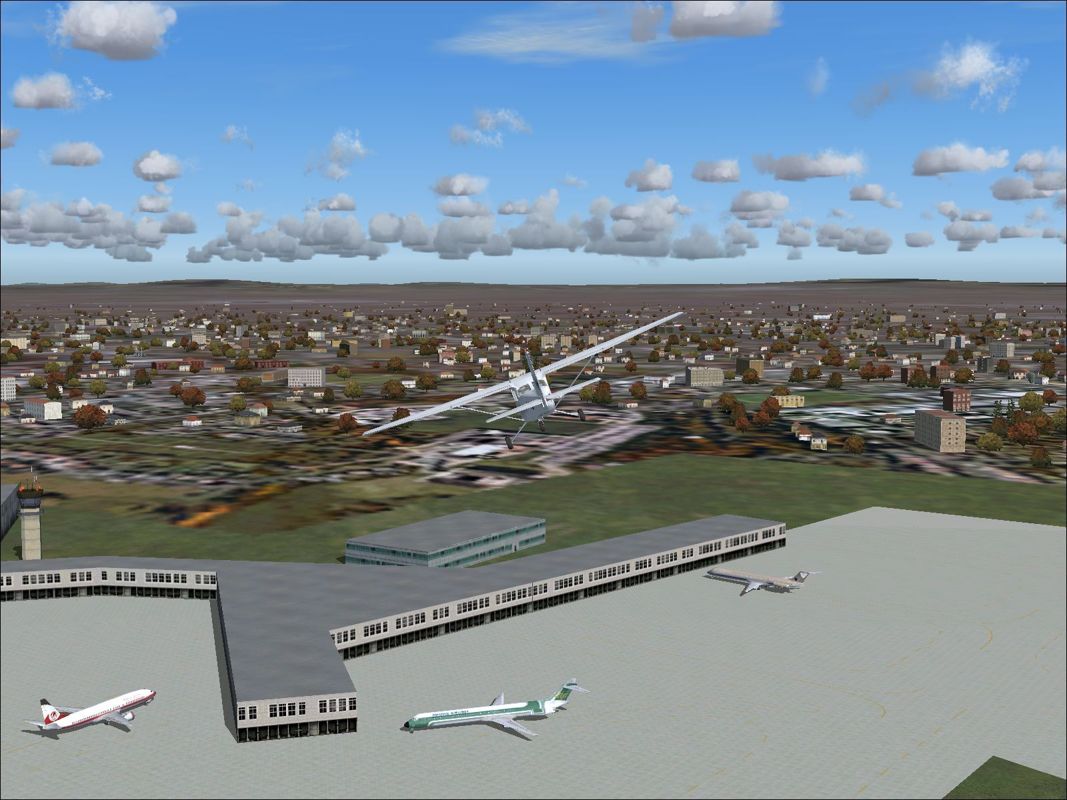 2005 Traffic (Windows) screenshot: This is Manchester airport, England. It's using the flight simulator's default scenery and default aircraft. Just the three planes on the ground Pacifica, World Travel and SOAR.