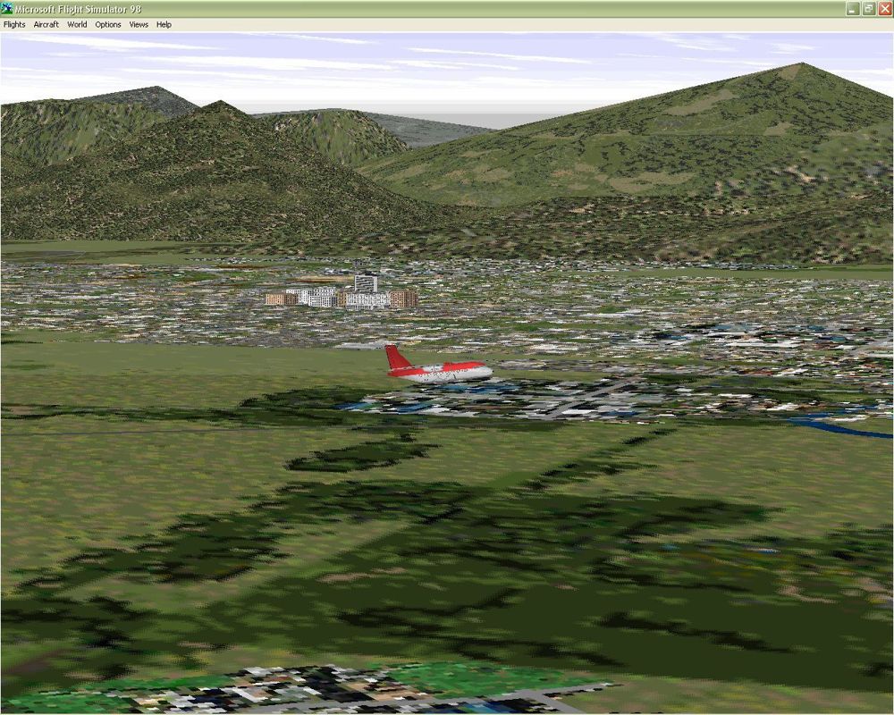 Dangerous Airports (Windows) screenshot: The ATR 42-300 taking off from Tribhuvan airport, Katmandu in Nepal looking across at the city. This is using the new scenery supplied with Dangerous Airports