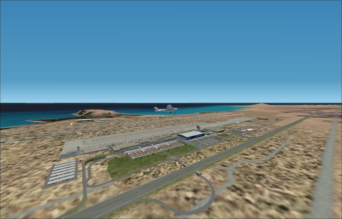 Scenery Spain 3: Canary Islands (Windows) screenshot: Gran Canaria by day from altitude, showing the extent of the airport. Flight Simulator 2002