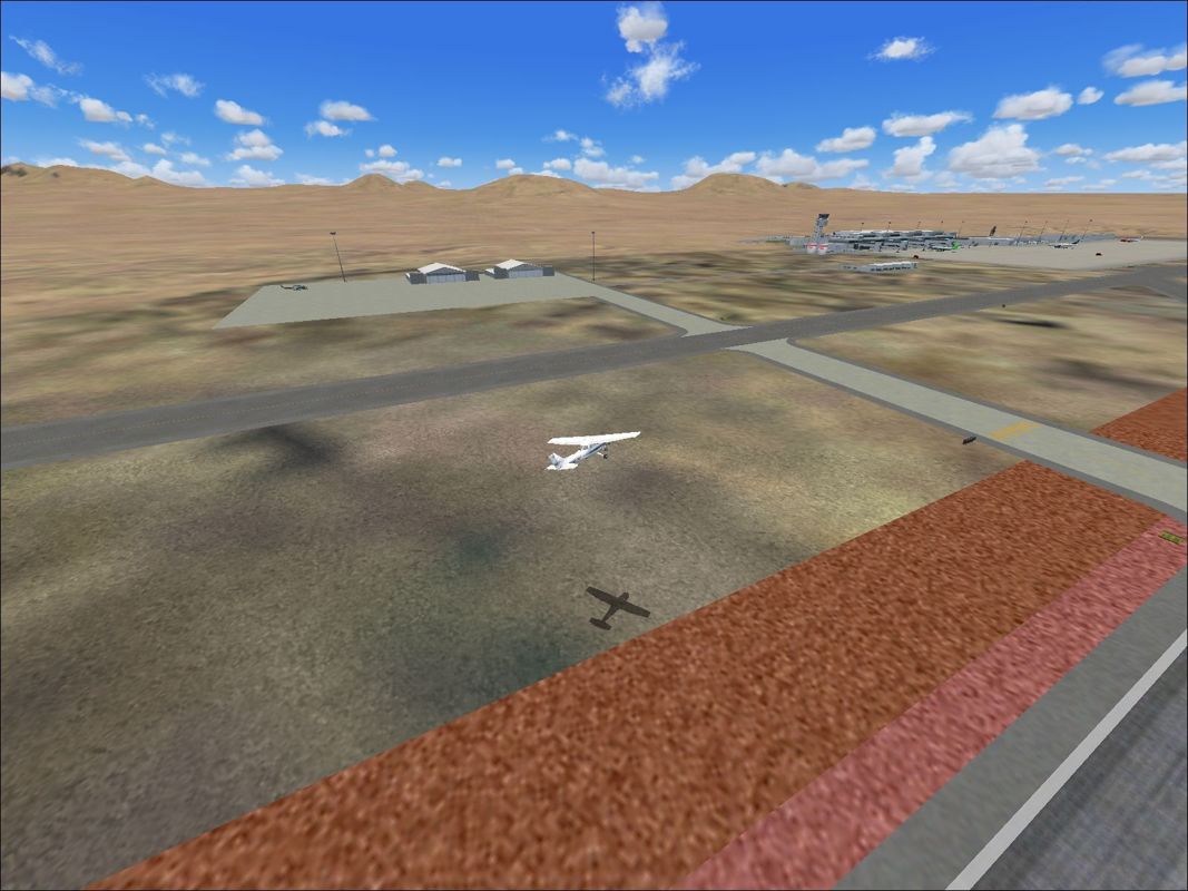 Scenery Spain 3: Canary Islands (Windows) screenshot: Lanzarote by day showing the buildings and static aircraft Flight Simulator 2004