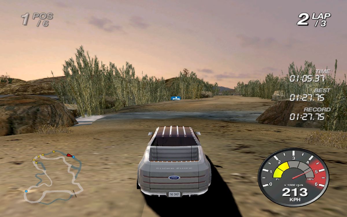Ford Racing Off Road (Windows) screenshot: Floating blue boxes with wrench logo, 2 per race, magically fix the car when driven over.