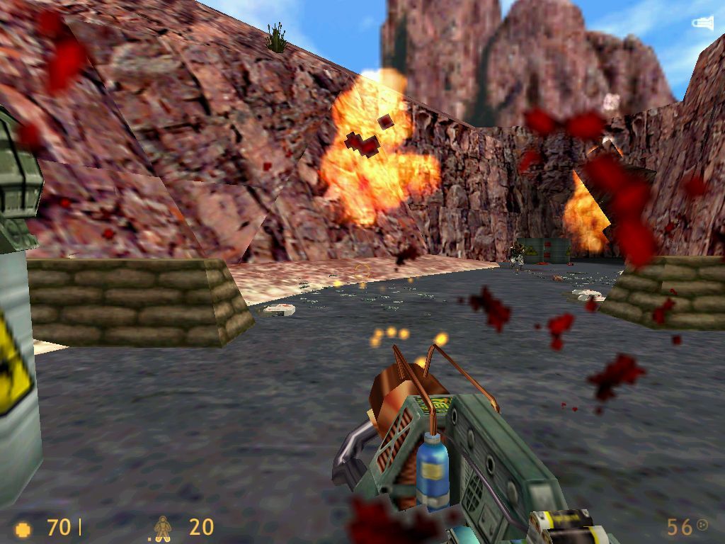 Half-Life (Windows) screenshot: An outdoor shootout with some marines. Witness explosive barrels and some blood effects