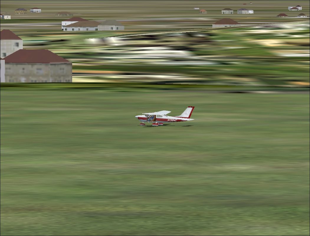 Greatest Airplanes: Cardinal! (Windows) screenshot: A grass parking off the end of the strip...still in one piece. Ground textures look a bit psychedelic up close.