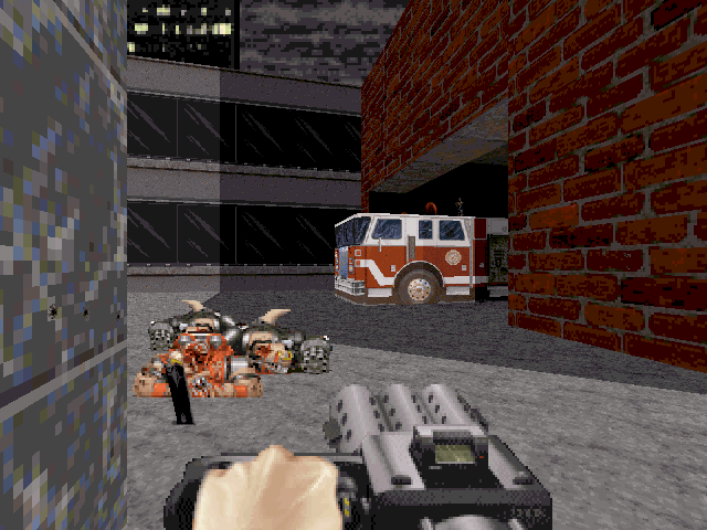Duke Nukem 3D (DOS) screenshot: Defeated enemies on the street late in Episode Three. A car is ahead