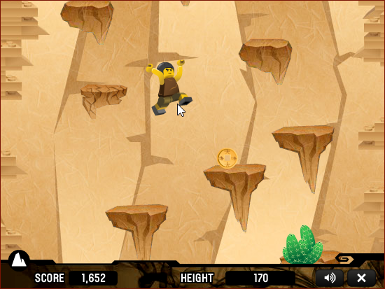 LEGO Four Paths (Browser) screenshot: Jumping towards a coin in <i>Rocky Road</i>. A cactus hazard is visible at the bottom of the screen.