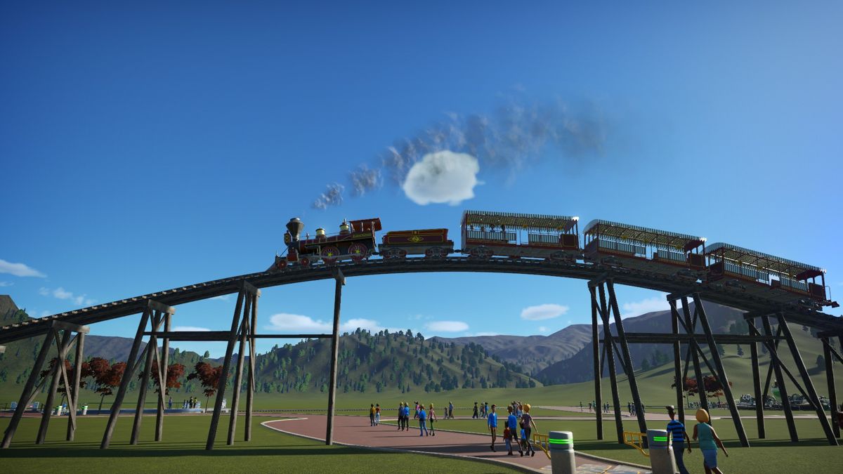 Planet Coaster (Windows) screenshot: You're able to build bridges so that your train rides can go over the footpaths
