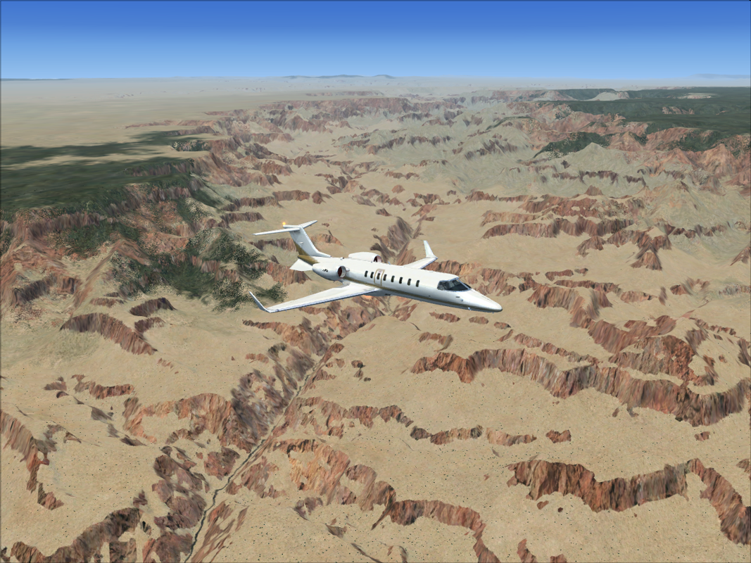 Microsoft Flight Simulator X (Windows) screenshot: Flying high over the Grand Canyon in a Learjet 45.