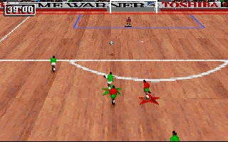 Striker '95 (DOS) screenshot: The striker shoots at goal in an indoor match.