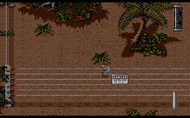 Jurassic Park (Amiga) screenshot: An electric fence blocks your way