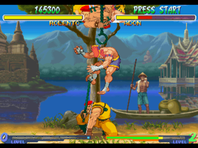 Street Fighter Alpha 2 (PlayStation) screenshot: Assisted by one of his soldiers, Rolento executes his 'Take No Prisoner' Super Combo in Adon.