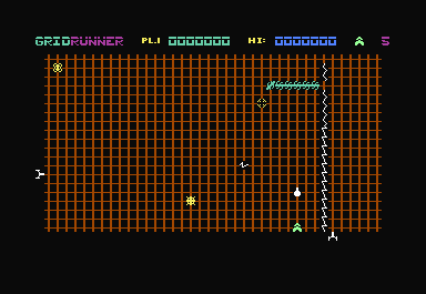 Gridrunner (Commodore 64) screenshot: As you shoot and move, you are also being shot at from below (see squiggle line to left of ship) and from the left side.
