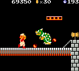 Super Mario Bros. Deluxe (Game Boy Color) screenshot: Before Bowser spits his fireball, Mario strikes back shooting some fireballs too.