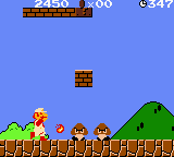 Super Mario Bros. Deluxe (Game Boy Color) screenshot: Fire Mario shoots a jumping flame ball in his next target: a double of Goombas.