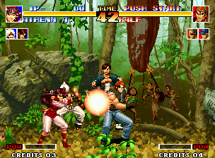 The King of Fighters '94 (Neo Geo) screenshot: Athena's Psycho Ball is avoided by Ralf.