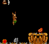 Chuck Rock (Game Gear) screenshot: Chuck jumps