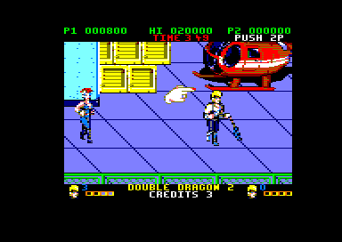 Double Dragon II: The Revenge (Amstrad CPC) screenshot: A finger points east (128K floppy disk version).