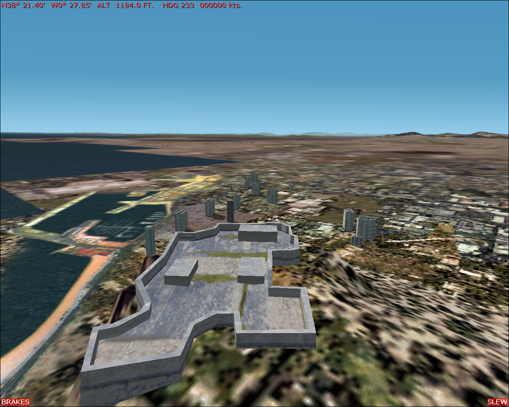 Scenery Spain 2: Spanish Airports (Windows) screenshot: Alicante city scenery - on a hill above the city resides an old fort, Santa Bárbara Castle. In the city, some buildings and a marina has been added.