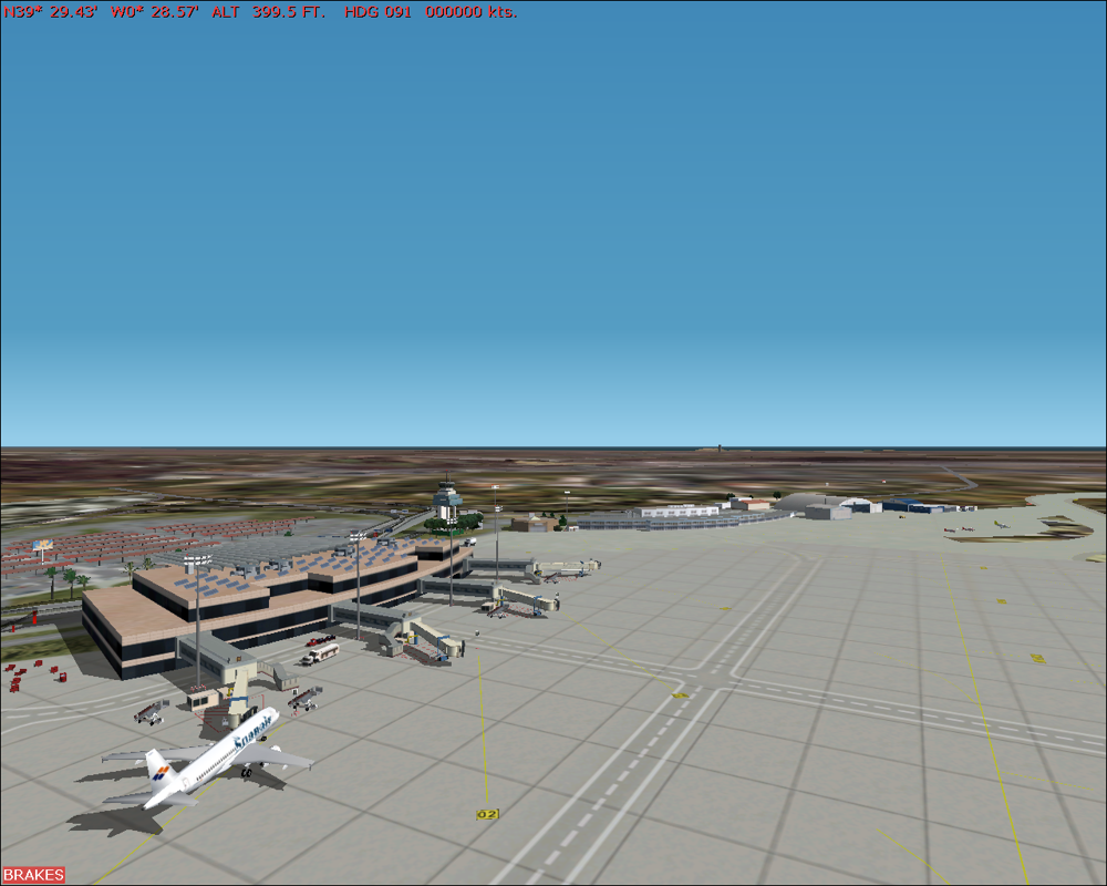 Scenery Spain 2: Spanish Airports (Windows) screenshot: Valencia airport - Terminal to left, tower behind it, service hangars right.
