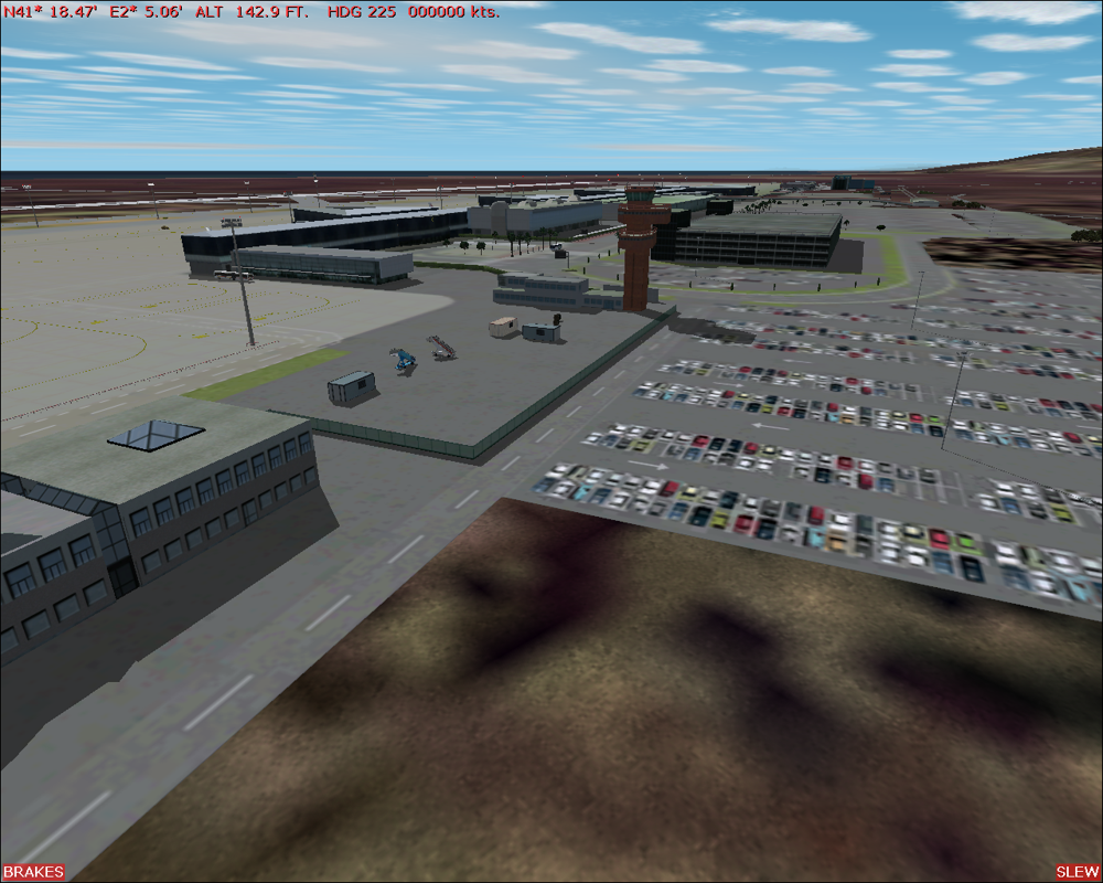 Scenery Spain 2: Spanish Airports (Windows) screenshot: Barcelona airport - control tower and open parking area behind terminals.