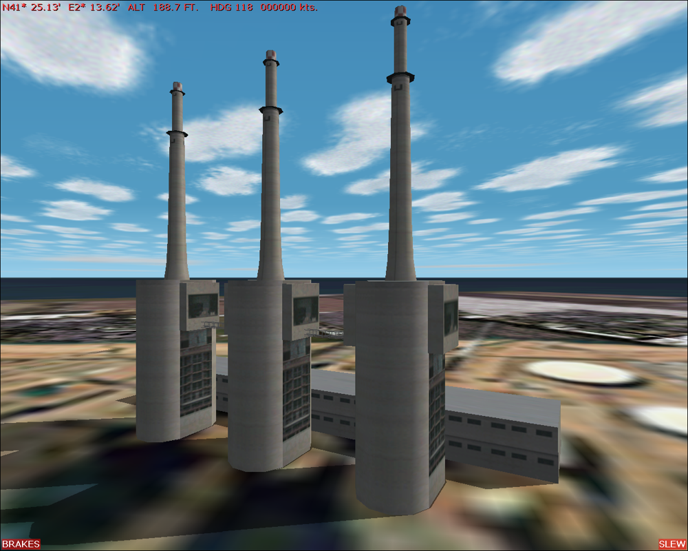 Scenery Spain 2: Spanish Airports (Windows) screenshot: Barcelona city scenery - the three chimeys at the old FECSA power plant. (Looking very much like giant cellular phones IMO)