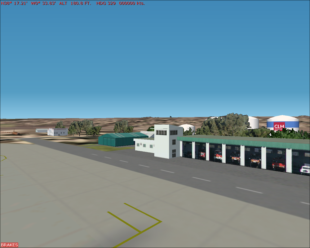 Scenery Spain 2: Spanish Airports (Windows) screenshot: Alicante airport - In a corner of the airport we find the rescue services, plus a brown husk of an aircraft for the rescuers to practice on.