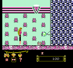 Barbie (NES) screenshot: The ball dispenser is the miniboss of the mall. Barbie must give crystals to the cat so the cat will swat at it. Meanwhile, she has to avoid the balls.