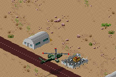 Desert Strike: Return to the Gulf (Game Boy Advance) screenshot: In the rubble of some buildings are pickups