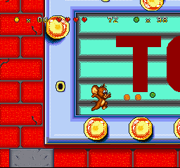 Tom and Jerry (SNES) screenshot: Jumping across the lights of the marquee sign, Jerry is about to collect cheese bits and a marble!